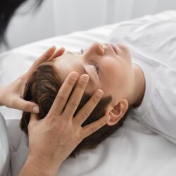 female-osteopathist-treating-boy-hospital