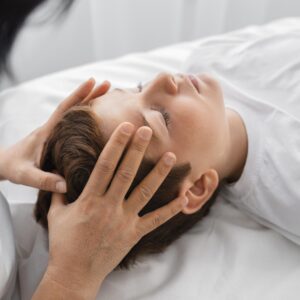 female-osteopathist-treating-boy-hospital