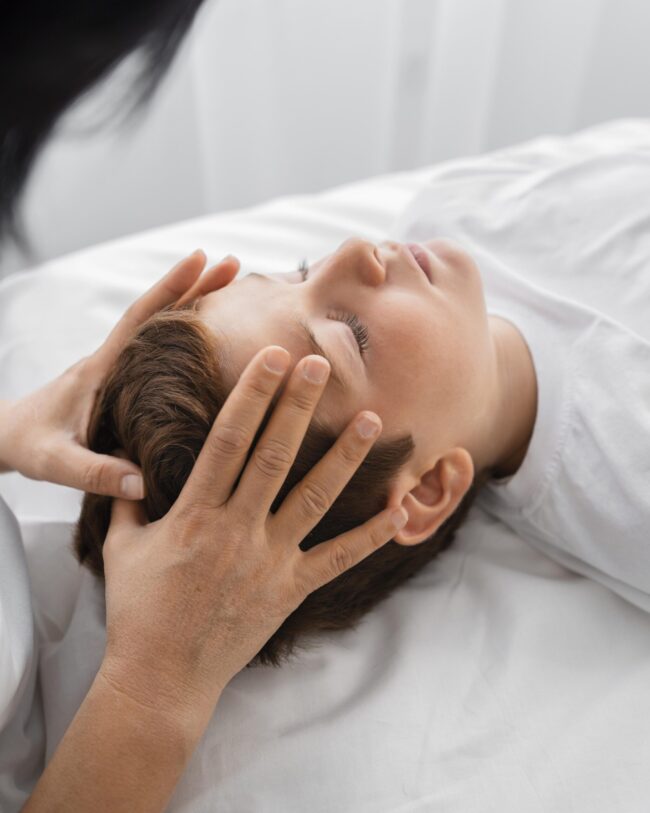 female-osteopathist-treating-boy-hospital